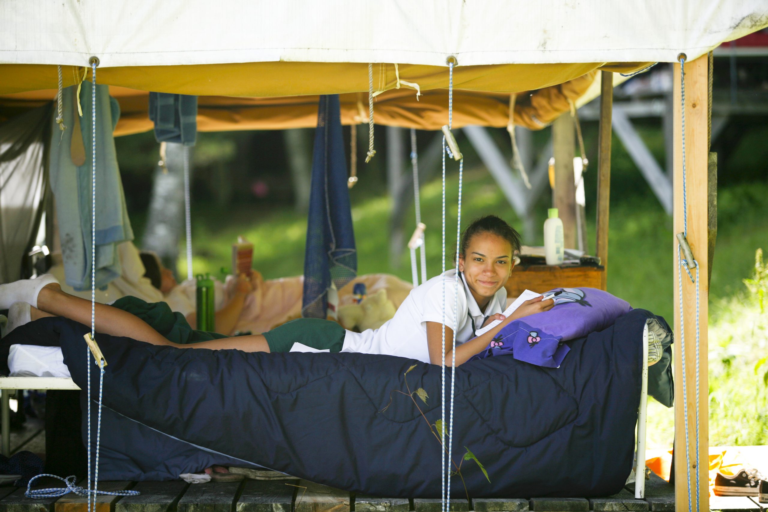 girl laying on her bunk bed reading